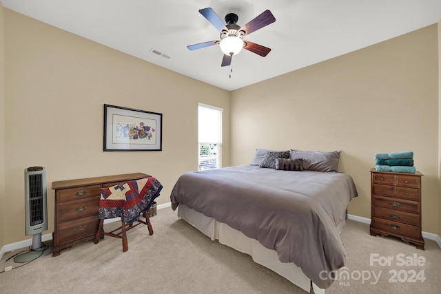 carpeted bedroom featuring ceiling fan and heating unit