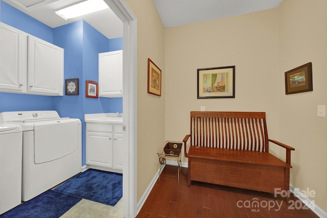 laundry room with dark hardwood / wood-style flooring, cabinets, sink, and washing machine and clothes dryer