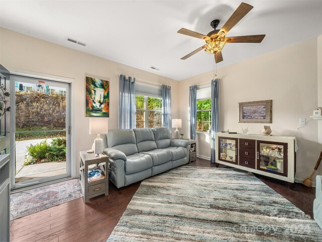 living room featuring ceiling fan and dark hardwood / wood-style flooring