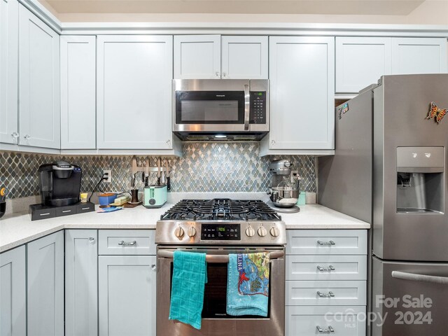 kitchen featuring appliances with stainless steel finishes and backsplash