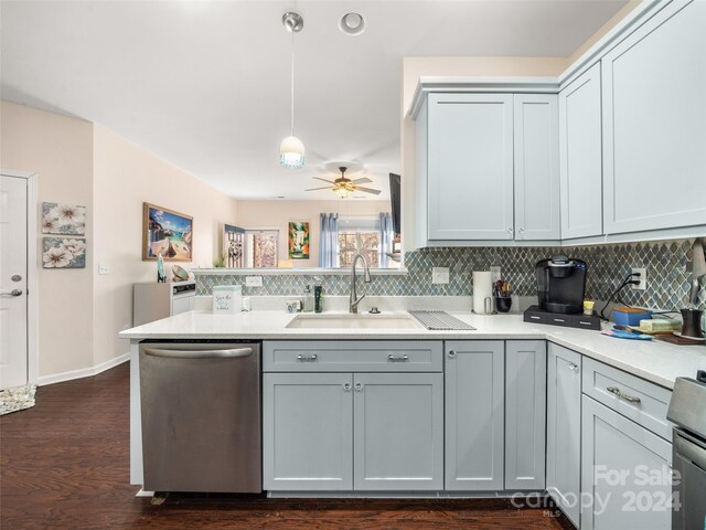 kitchen featuring sink, ceiling fan, appliances with stainless steel finishes, decorative light fixtures, and kitchen peninsula