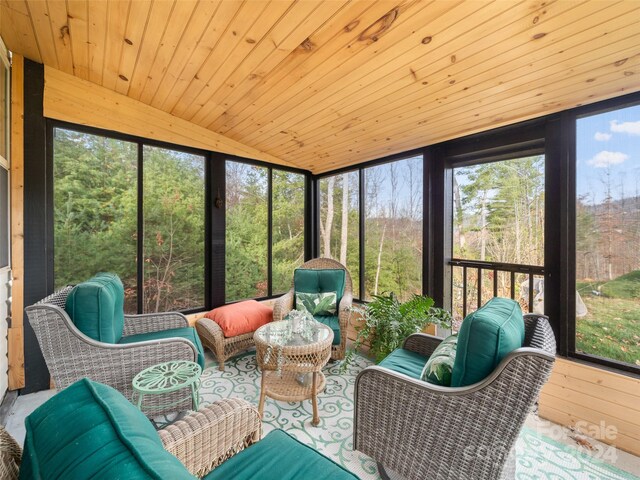 sunroom / solarium with a wealth of natural light, lofted ceiling, and wood ceiling