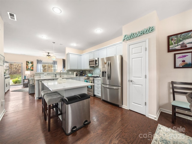 503 Rosebud Orchid Way, Weaverville, NC 28787 - kitchen with stainless steel appliances, light countertops, backsplash, dark wood-style floors, and a peninsula
