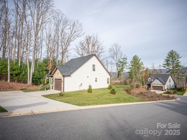 503 Rosebud Orchid Way, Weaverville, NC 28787 - view of property exterior featuring a garage, a yard, driveway, and roof with shingles