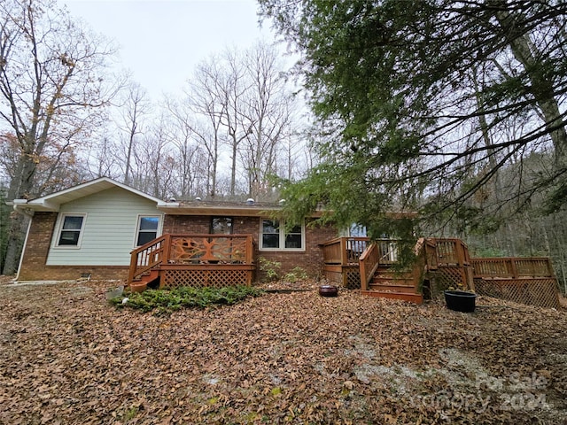 rear view of house with a wooden deck