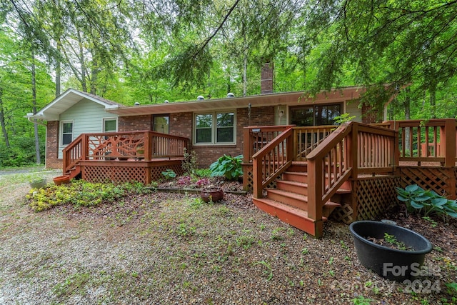 back of property with a wooden deck