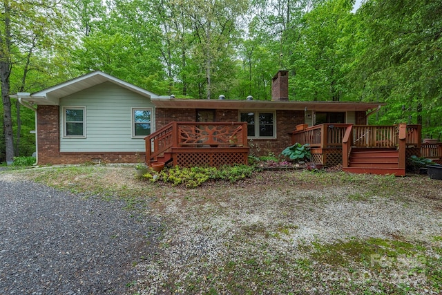 back of property with a wooden deck