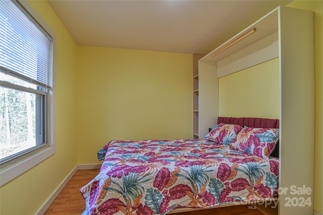 bedroom with hardwood / wood-style flooring