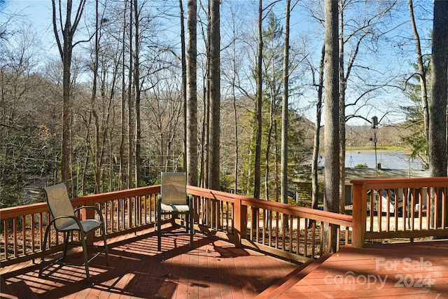 wooden terrace featuring a water view