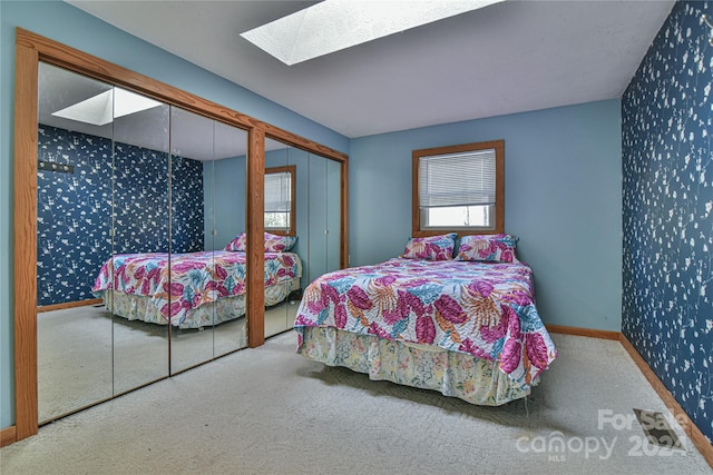 bedroom featuring carpet flooring and a skylight