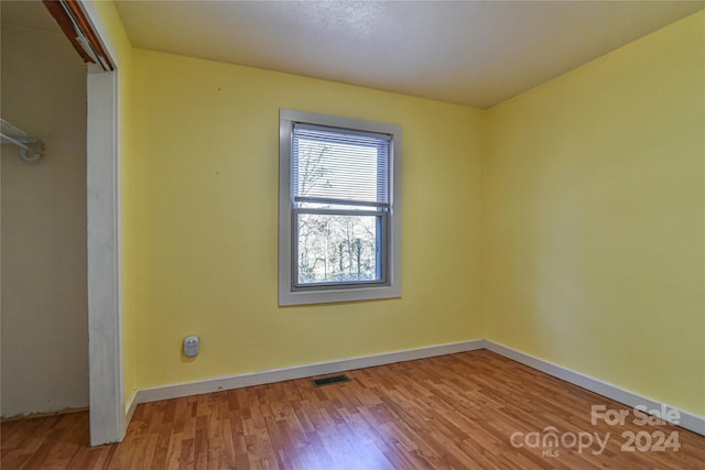 empty room with hardwood / wood-style flooring