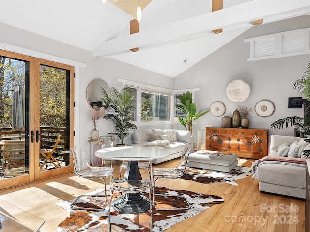 living room with hardwood / wood-style floors, high vaulted ceiling, french doors, and beam ceiling