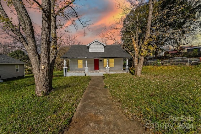 view of front of property featuring a lawn and covered porch