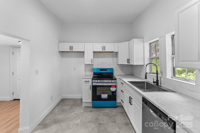 612 E E St, Newton, NC 28658 - kitchen featuring appliances with stainless steel finishes, a sink, white cabinetry, and tasteful backsplash