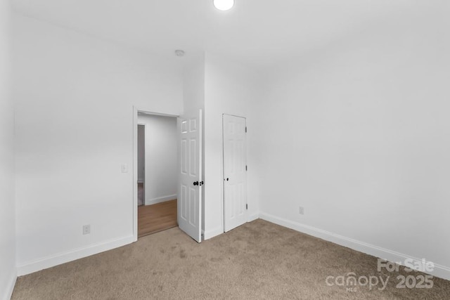 612 E E St, Newton, NC 28658 - unfurnished bedroom featuring light colored carpet and baseboards