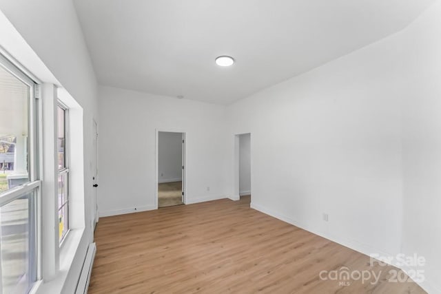 612 E E St, Newton, NC 28658 - unfurnished room featuring light wood-style floors, baseboard heating, and baseboards