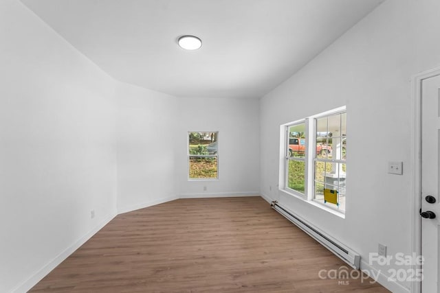 612 E E St, Newton, NC 28658 - empty room featuring a baseboard radiator, wood finished floors, and baseboards
