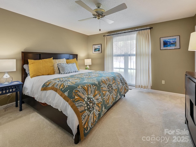 bedroom with light carpet, a textured ceiling, and ceiling fan