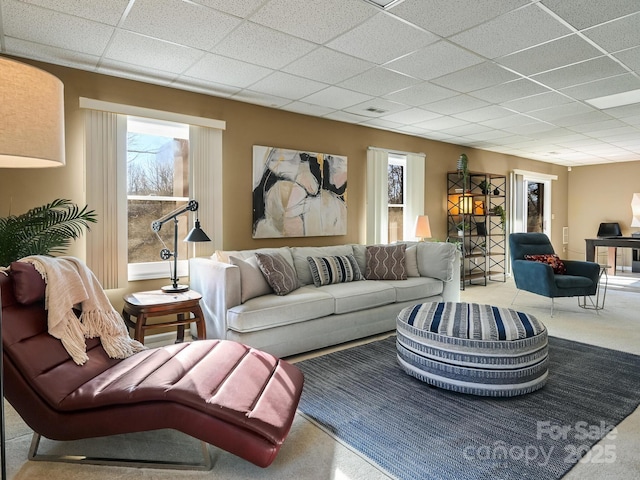 living room featuring a paneled ceiling