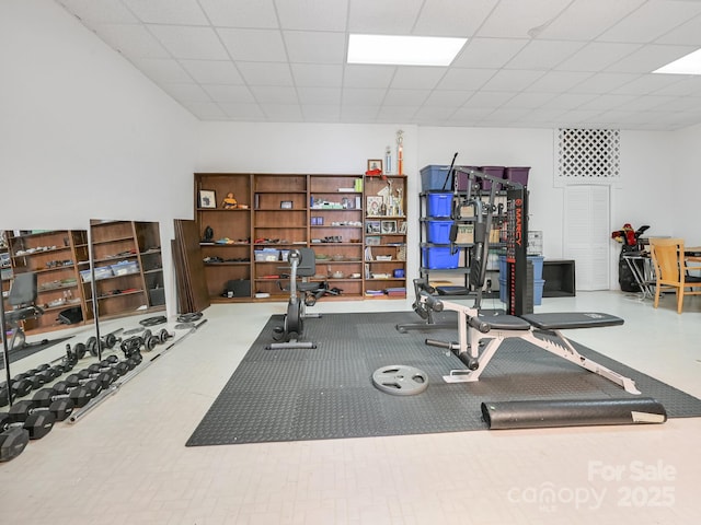 exercise room with a paneled ceiling