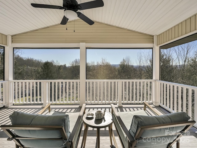 sunroom / solarium featuring ceiling fan, plenty of natural light, and lofted ceiling