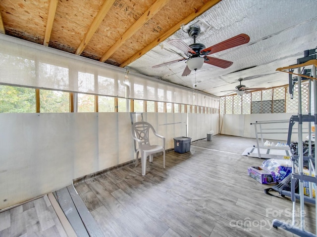 unfurnished sunroom with ceiling fan