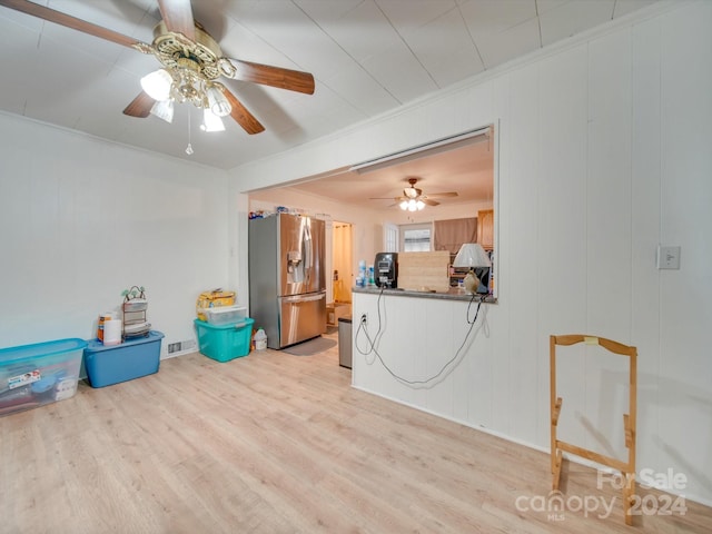 interior space featuring ceiling fan, light hardwood / wood-style flooring, and ornamental molding