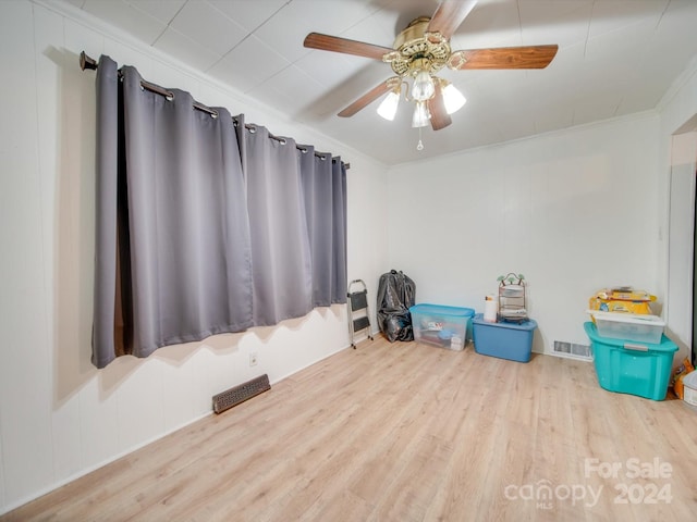 miscellaneous room featuring ceiling fan, light hardwood / wood-style flooring, and ornamental molding