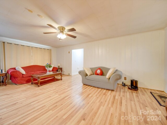 living room with light hardwood / wood-style floors and ceiling fan