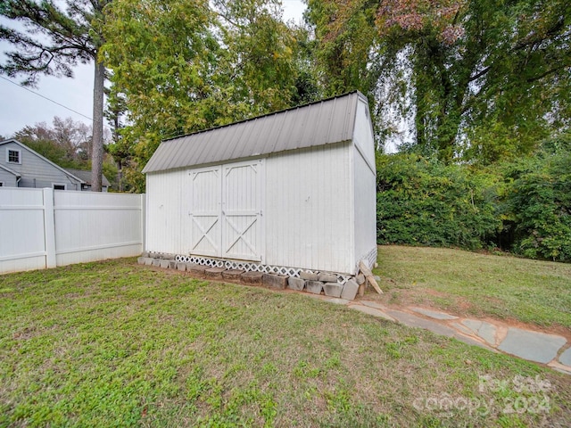 view of outbuilding with a lawn