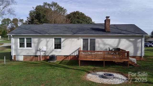 back of property with a wooden deck, a yard, central AC unit, and an outdoor fire pit