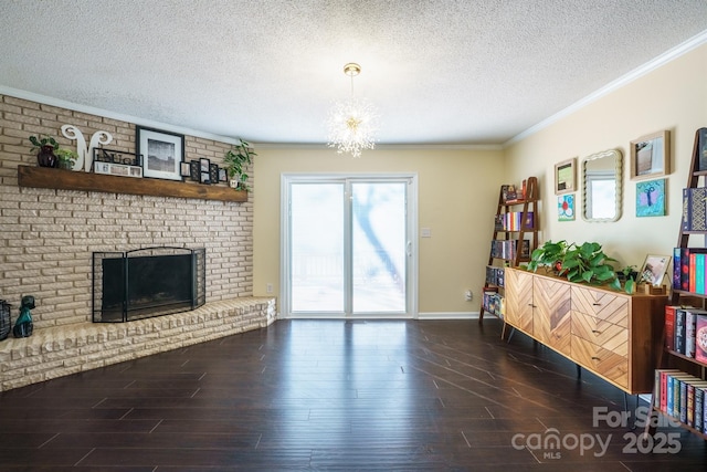 living room with crown molding, a brick fireplace, dark wood-type flooring, and a textured ceiling