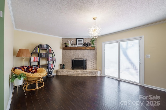 living room with crown molding, hardwood / wood-style floors, a textured ceiling, and a fireplace