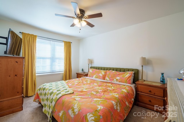 bedroom featuring ceiling fan and carpet