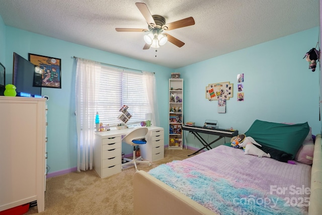 carpeted bedroom featuring ceiling fan and a textured ceiling