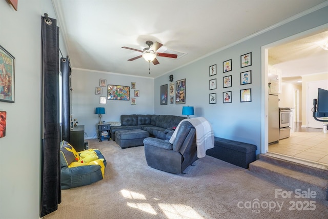 carpeted living room with crown molding and ceiling fan