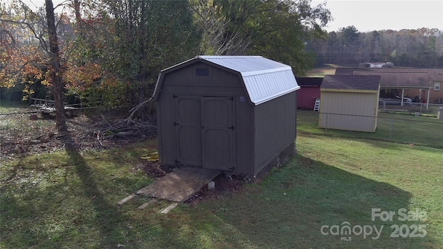 view of outbuilding with a yard