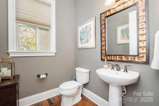 bathroom with hardwood / wood-style floors and toilet