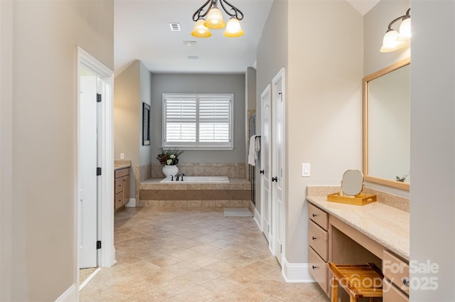 bathroom with tile patterned floors, vanity, a relaxing tiled tub, and a notable chandelier