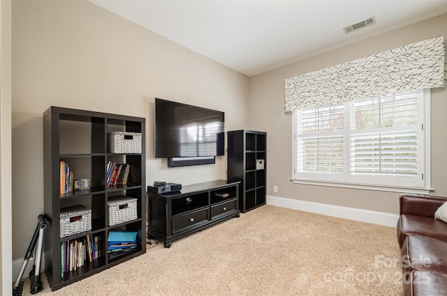 living area featuring light colored carpet