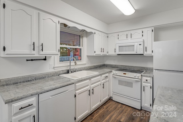 kitchen with dark hardwood / wood-style flooring, sink, white cabinets, and white appliances