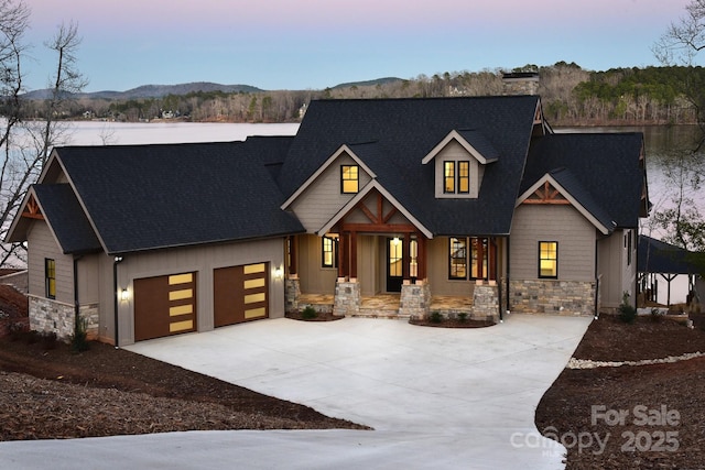 view of front of house with a mountain view, a porch, and a garage