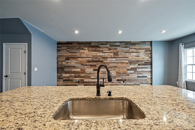 kitchen with light stone countertops and sink