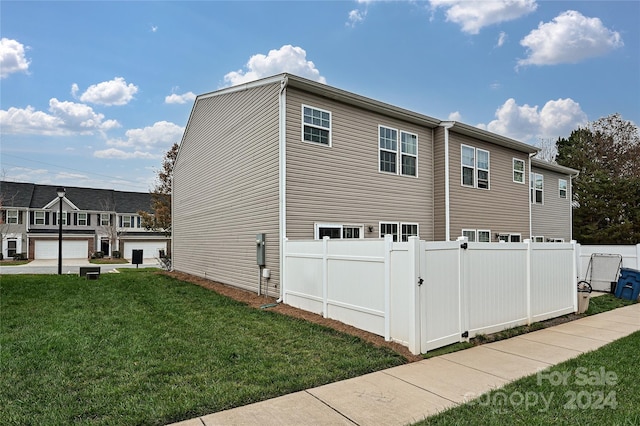 view of side of property with a lawn