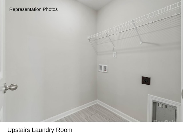 laundry area with hookup for an electric dryer, washer hookup, and light hardwood / wood-style floors