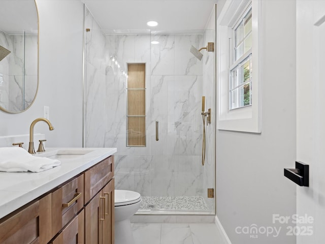 bathroom featuring vanity, toilet, and an enclosed shower