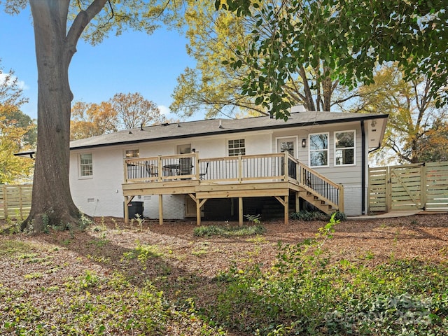 back of property featuring a wooden deck