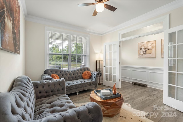 living room with french doors, light hardwood / wood-style floors, ceiling fan, and crown molding