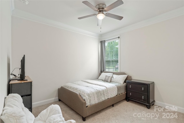 carpeted bedroom with ceiling fan and ornamental molding