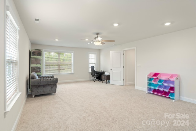 home office featuring ceiling fan and light colored carpet